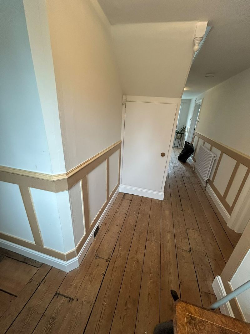 A hallway with new timber wall panelling