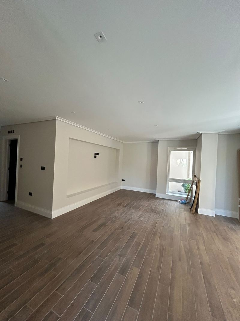 A finished open-plan apartment living space with clean walls and ceilings