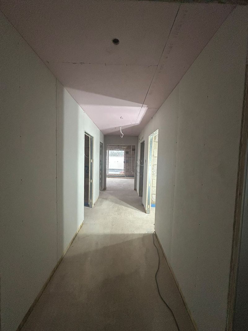 A corridor at Oakfield House in Dorridge, fully drylined and ready for finishing