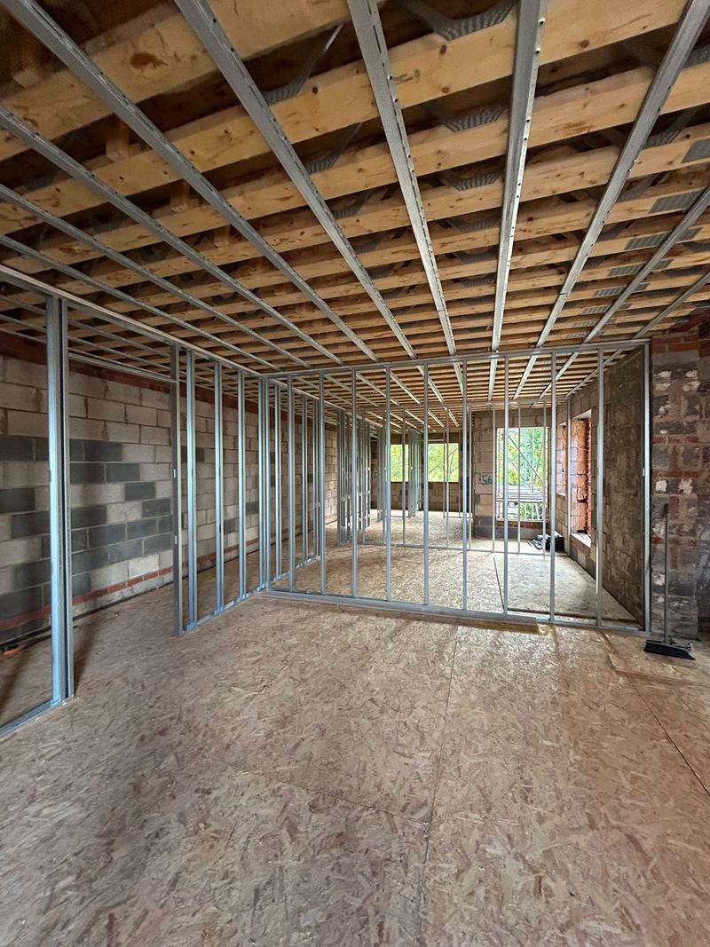 Metal stud partitions being built across a floor at Oakfield House, Dorridge
